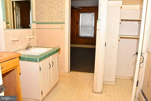 a view of a hallway with wooden walls