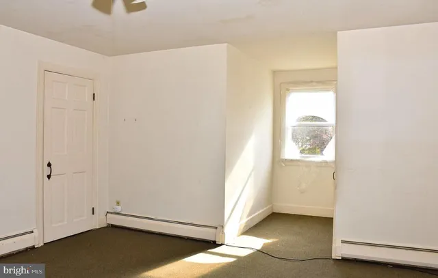 a view of a hallway with a white walls