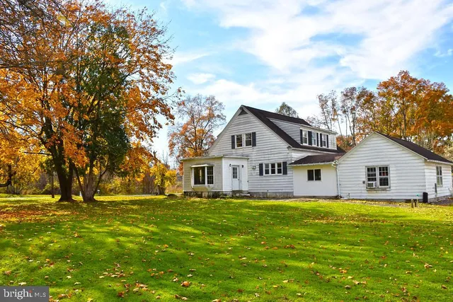 a front view of house with yard and green space
