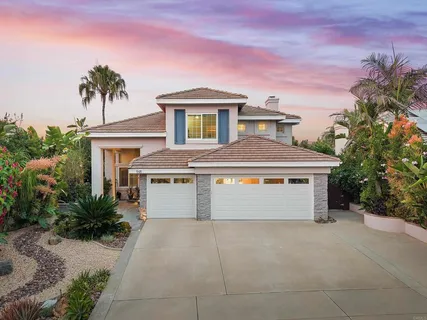 a front view of a house with a yard and a garage