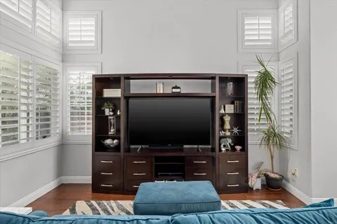 a view of a dining room with furniture a chandelier and wooden floor