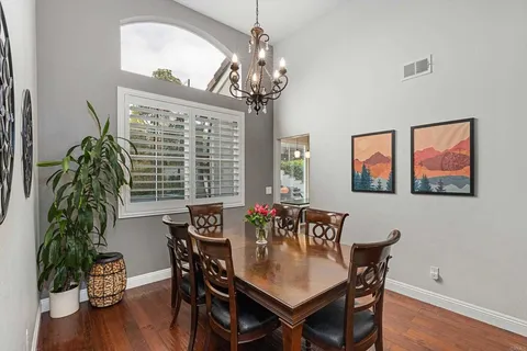 a kitchen with granite countertop a refrigerator and a stove top oven
