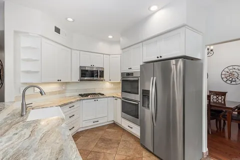 a view of a hallway with wooden floor and stairs