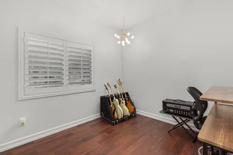 a bedroom with a bed and large mirror