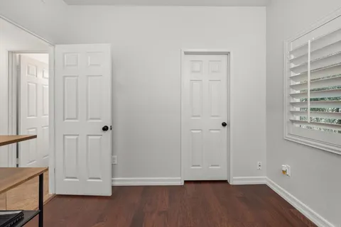 a roof deck with table and chairs potted plants with wooden floor