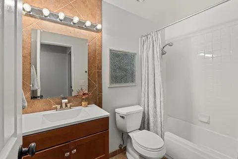 a spacious bedroom with a bed and a flat screen tv