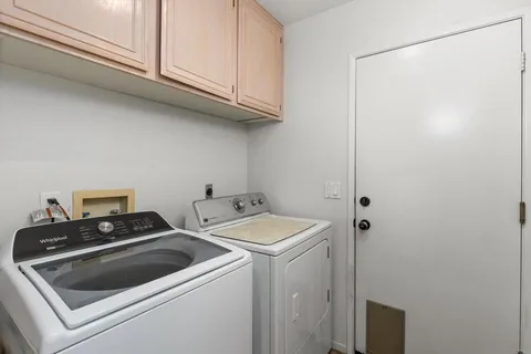 a spacious bathroom with a tub sink shower and mirror