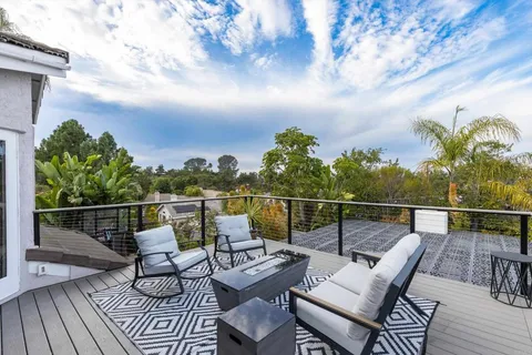 a view of a patio with table and chairs