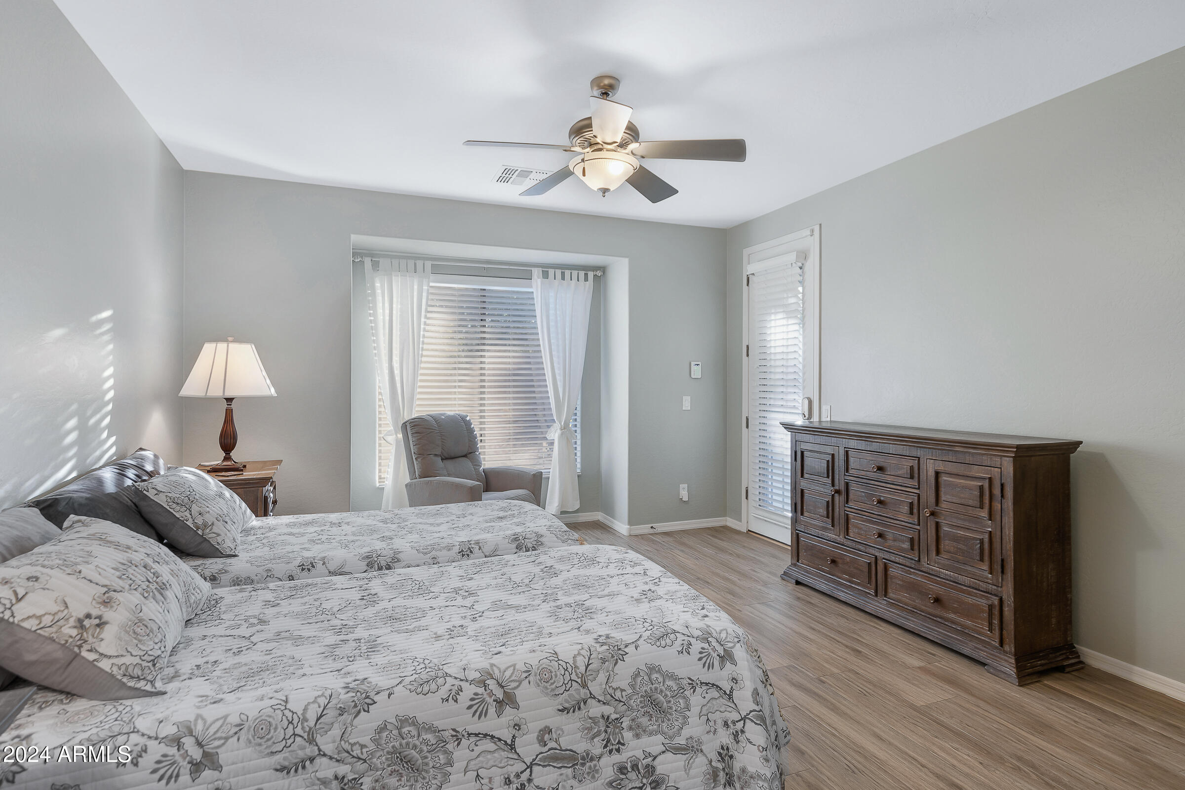 4741 East Timberline Road Gilbert, AZ 85297 - Photo 17 of 44 a large bedroom with a bed and a chandelier