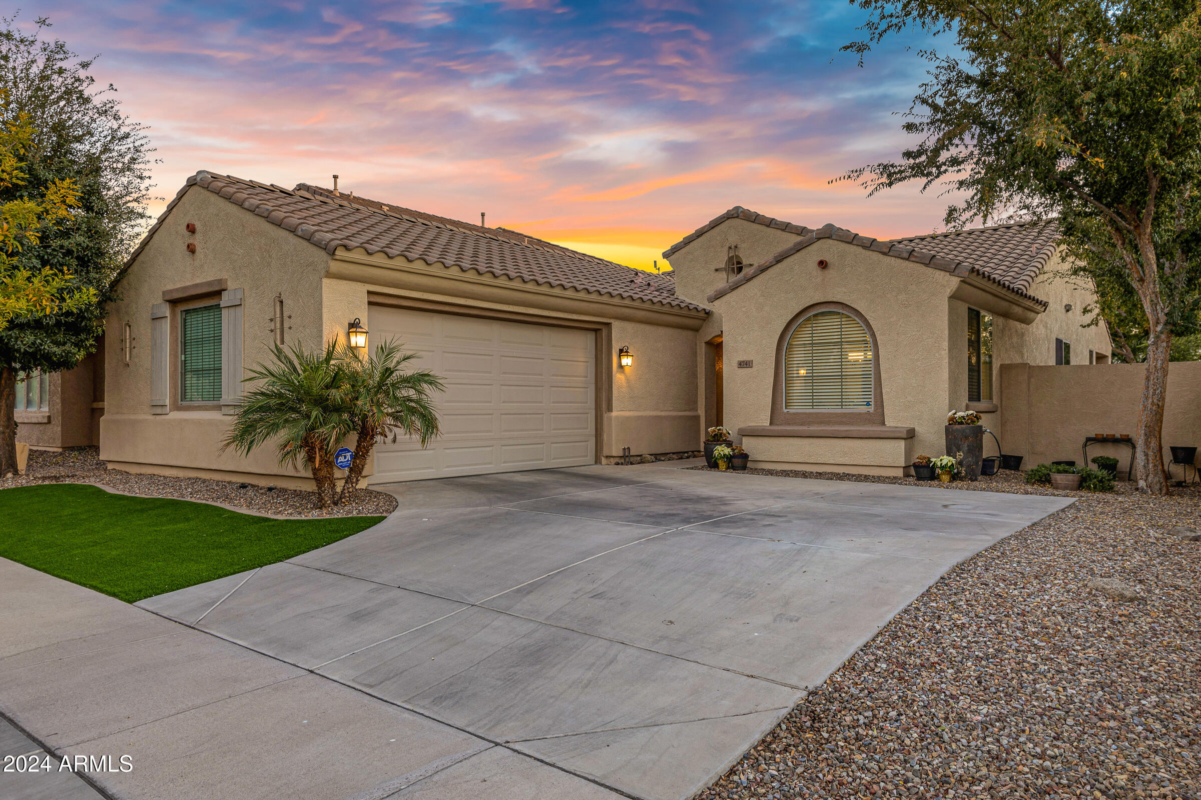 4741 East Timberline Road Gilbert, AZ 85297 - Photo 2 of 44 a front view of a house with a yard and garage