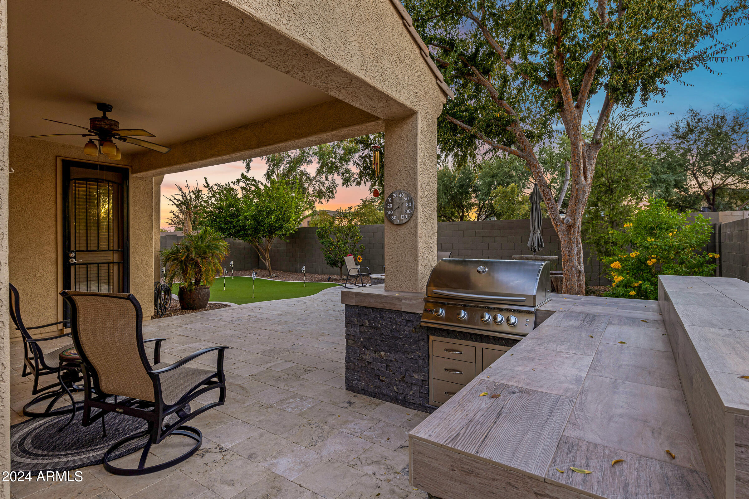 4741 East Timberline Road Gilbert, AZ 85297 - Photo 36 of 44 a view of a patio with a table chairs and a backyard