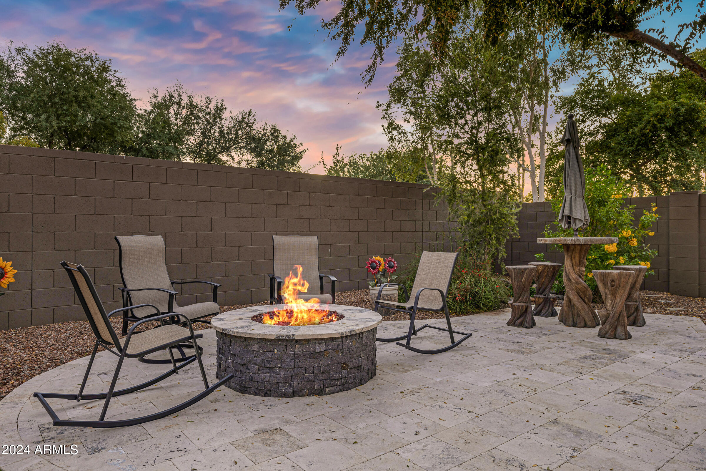 4741 East Timberline Road Gilbert, AZ 85297 - Photo 39 of 44 a view of a patio with table and chairs and a floor to ceiling window