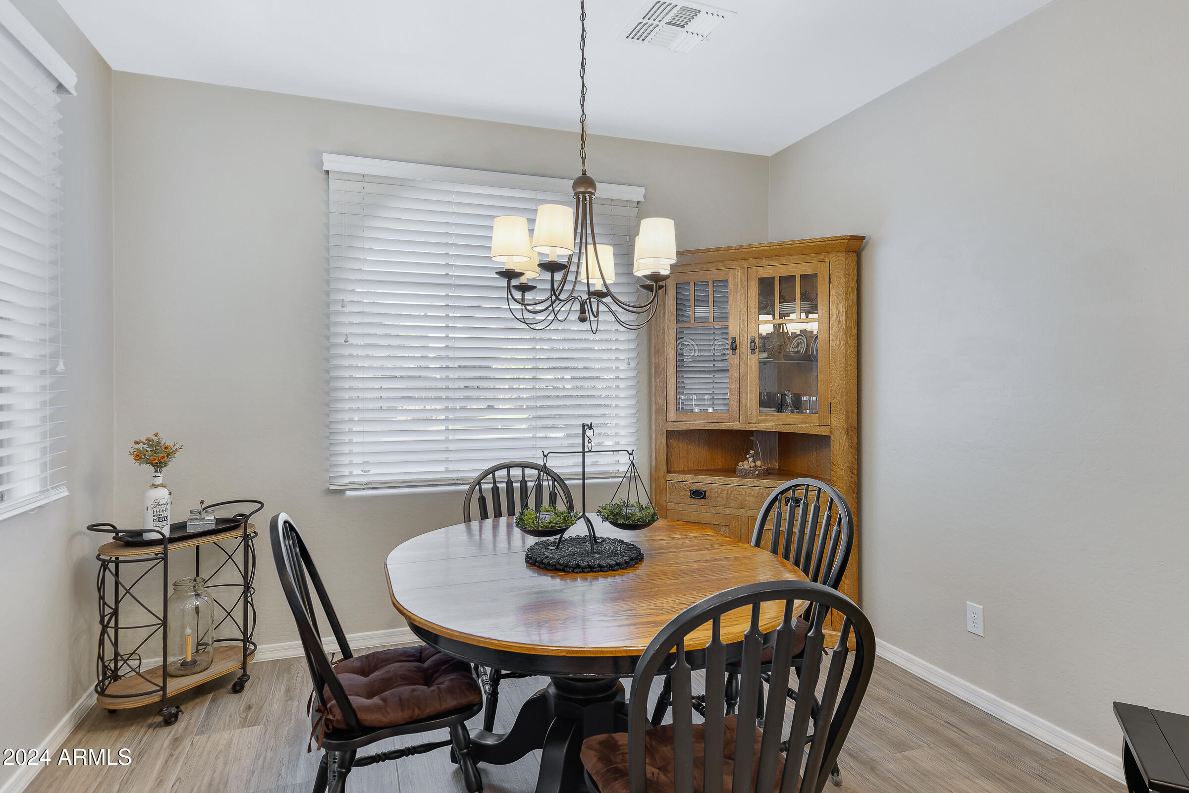 4741 East Timberline Road Gilbert, AZ 85297 - Photo 10 of 44 a view of a dining room with furniture and wooden floor