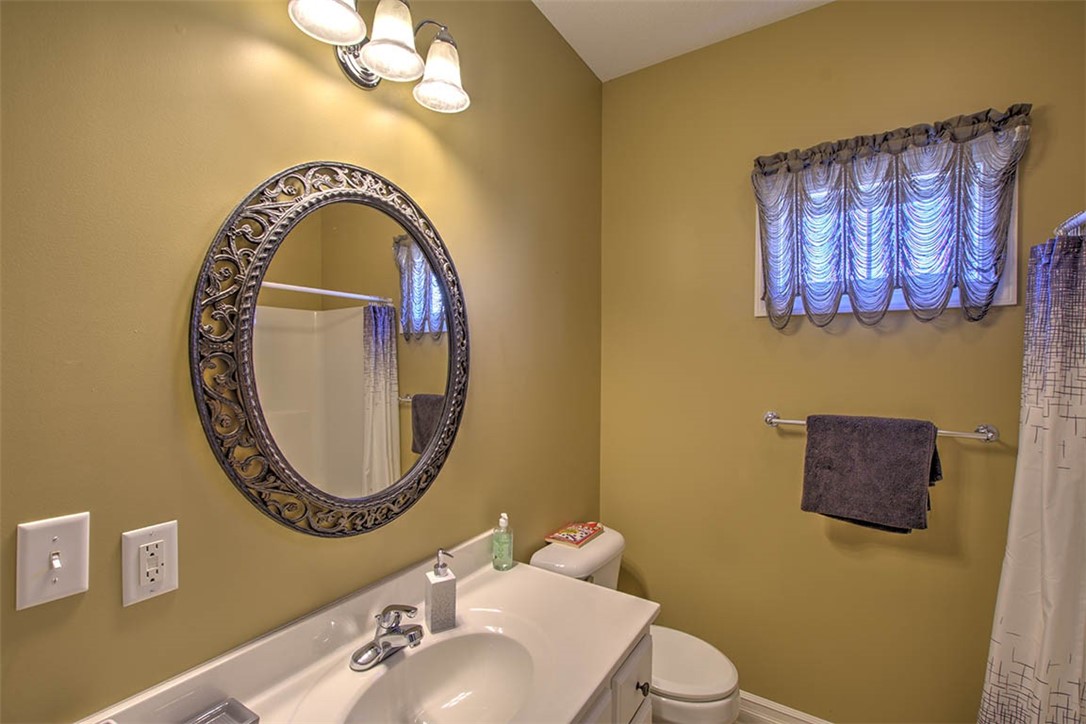 6625 Sherry Court Decatur, IL 62521 - Photo 22 of 42 a bathroom with a sink mirror and toilet