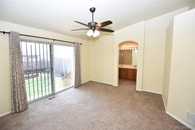 a view of a livingroom with a ceiling fan and window