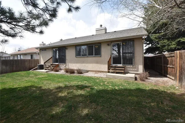 a backyard of a house with lots of green space and lake view