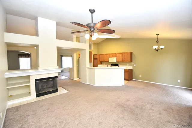 a view of a kitchen with a stove and a ceiling fan