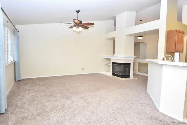 an empty room with a kitchen and a sink