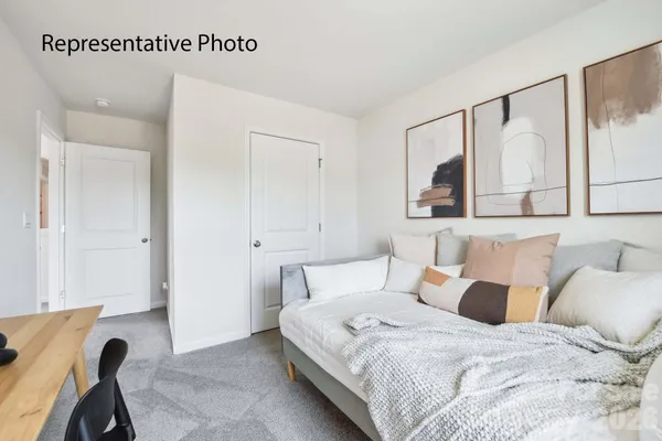 a bedroom with a bed a mirror and a window