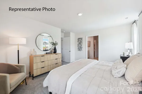 a bedroom with a bed and a couch