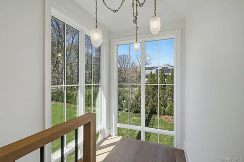 a view of a room with balcony and floor to ceiling windows