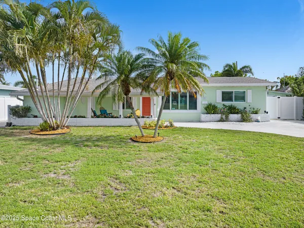 a house with palm tree in front of it
