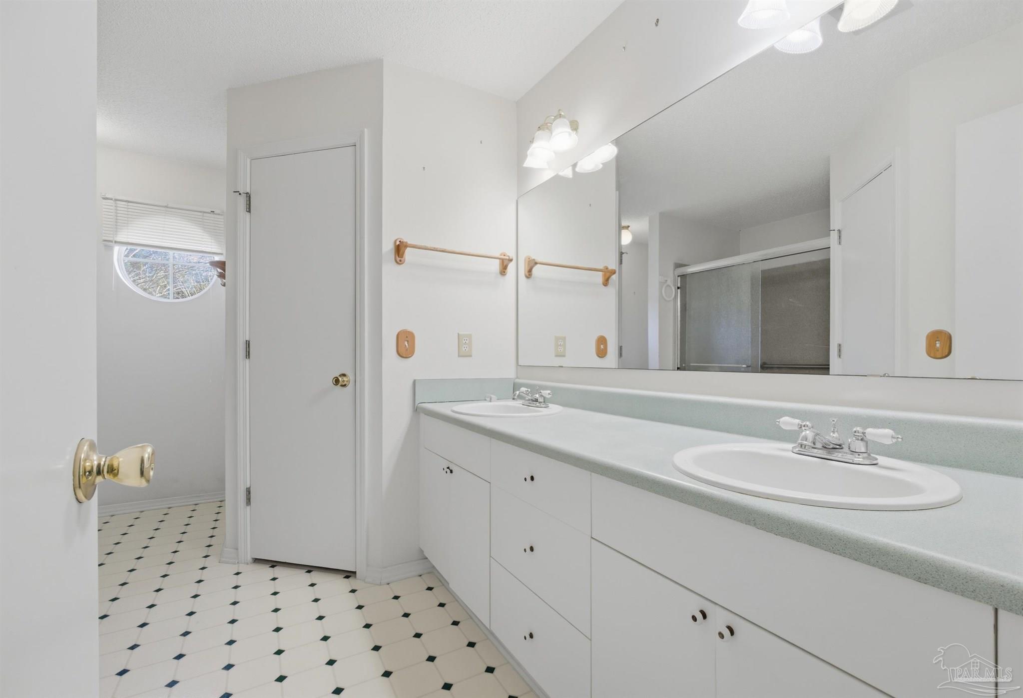 4327 Chantilly Way Milton, FL 32583 - Photo 11 of 32 a bathroom with a shower sink and mirror