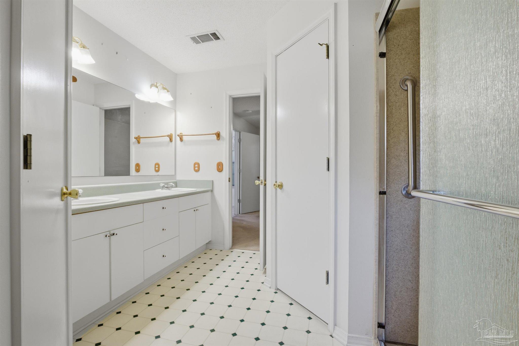 4327 Chantilly Way Milton, FL 32583 - Photo 12 of 32 a bathroom with a double vanity sink a mirror and a shower