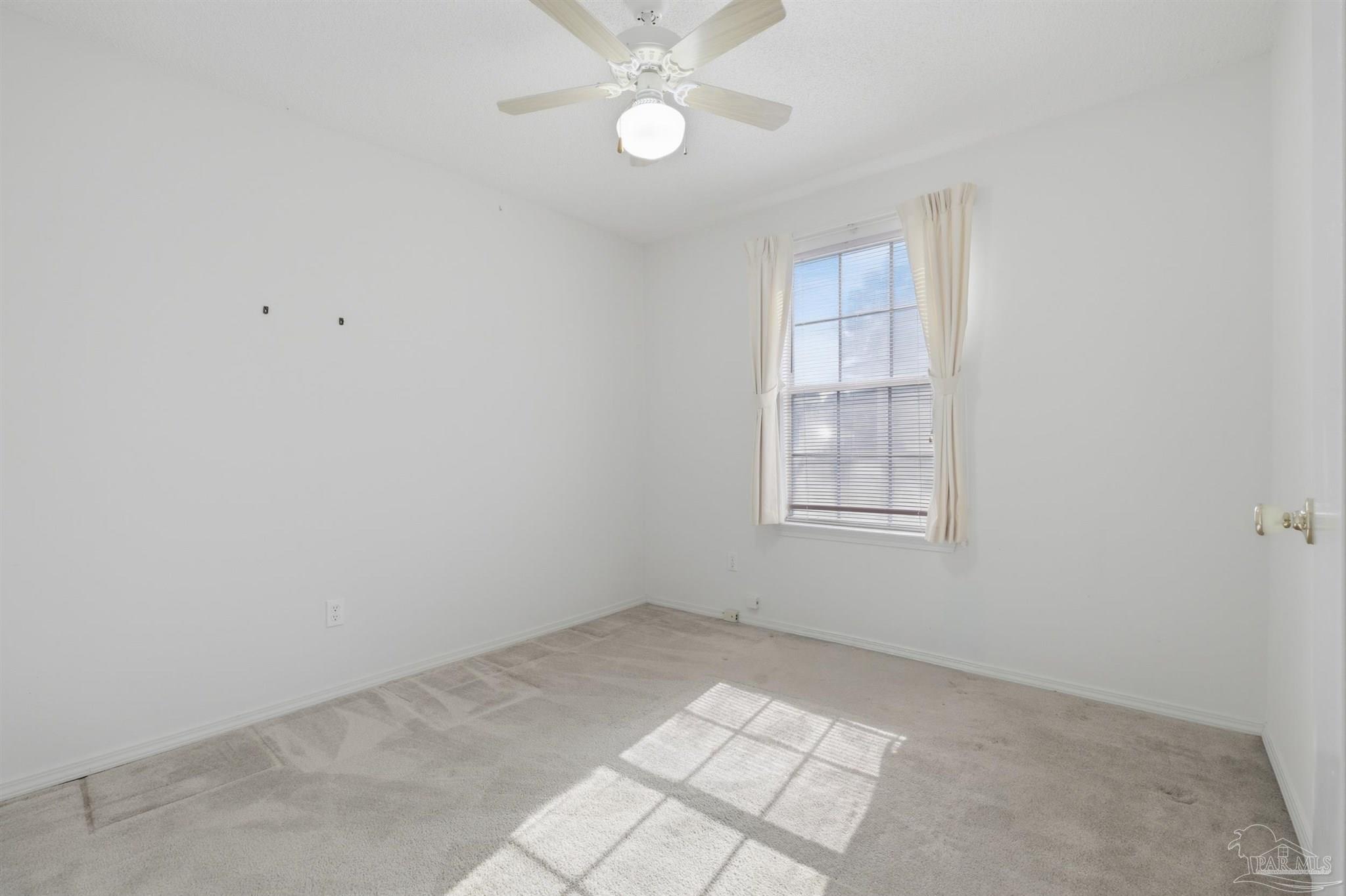 4327 Chantilly Way Milton, FL 32583 - Photo 15 of 32 an empty room with a window and ceiling fan