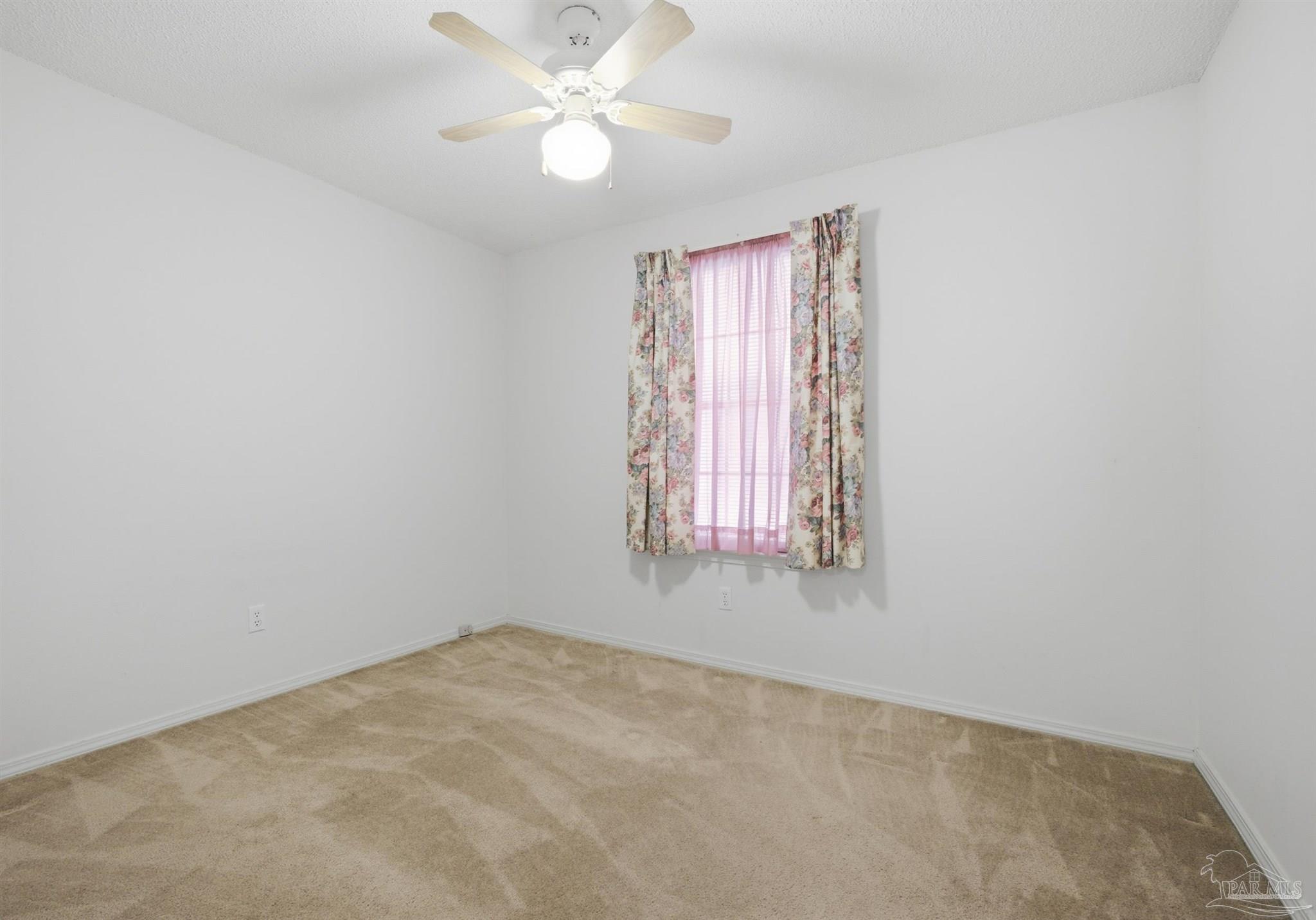 4327 Chantilly Way Milton, FL 32583 - Photo 17 of 32 an empty room with windows and fan