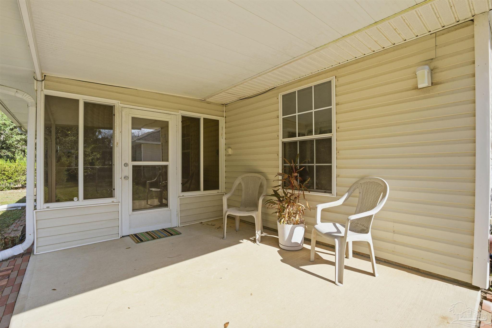 4327 Chantilly Way Milton, FL 32583 - Photo 20 of 32 a chair and table in front of a house