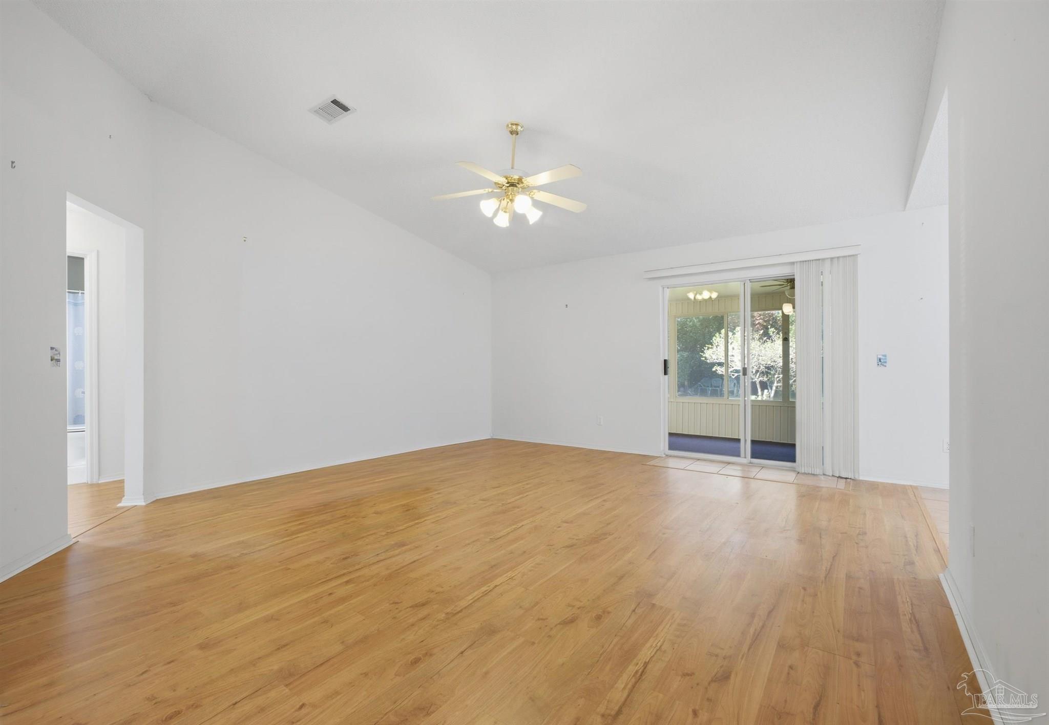 4327 Chantilly Way Milton, FL 32583 - Photo 2 of 32 a view of an empty room with a window and wooden floor