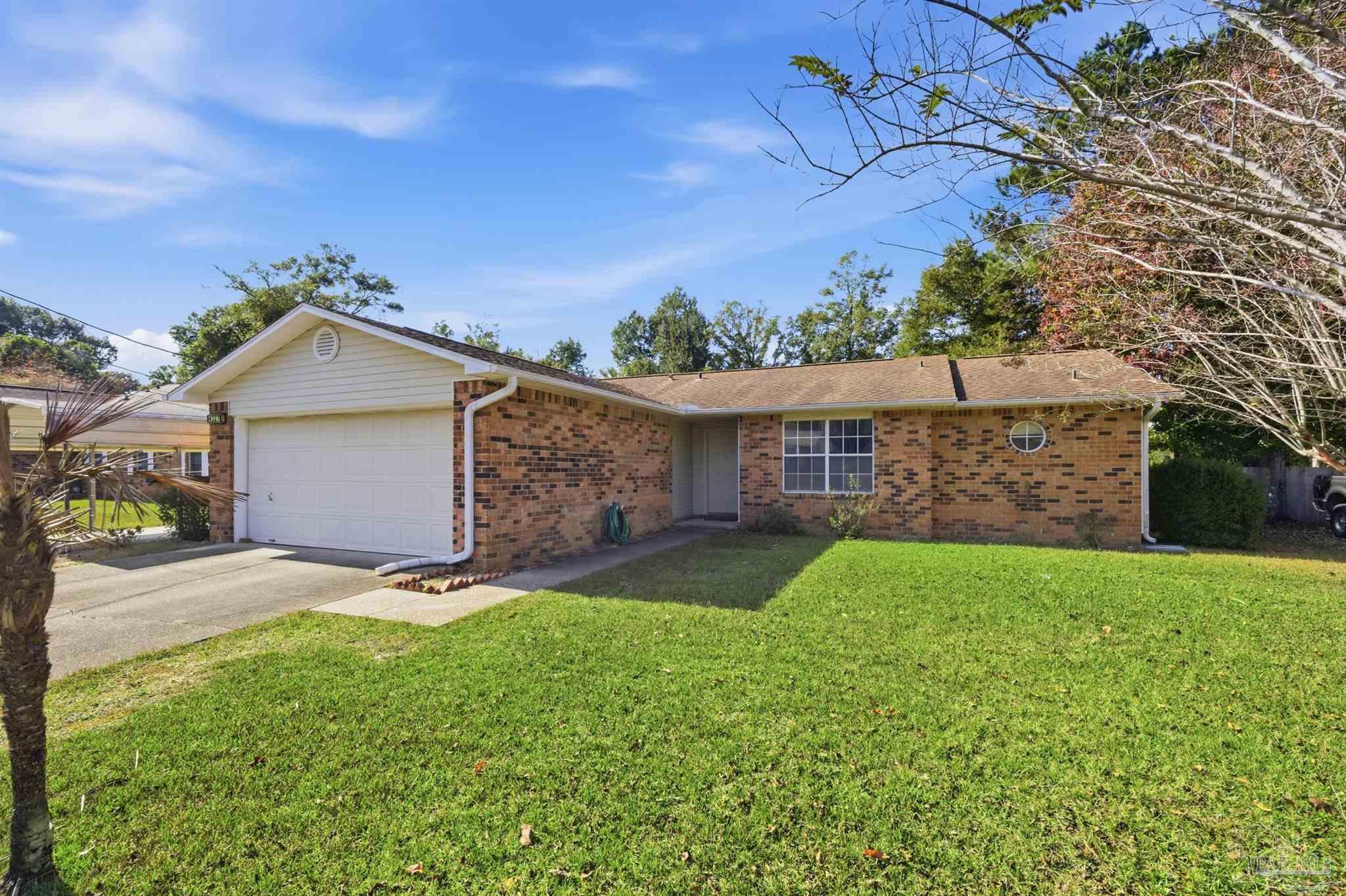 4327 Chantilly Way Milton, FL 32583 - Photo 28 of 32 a front view of house with yard and outdoor seating