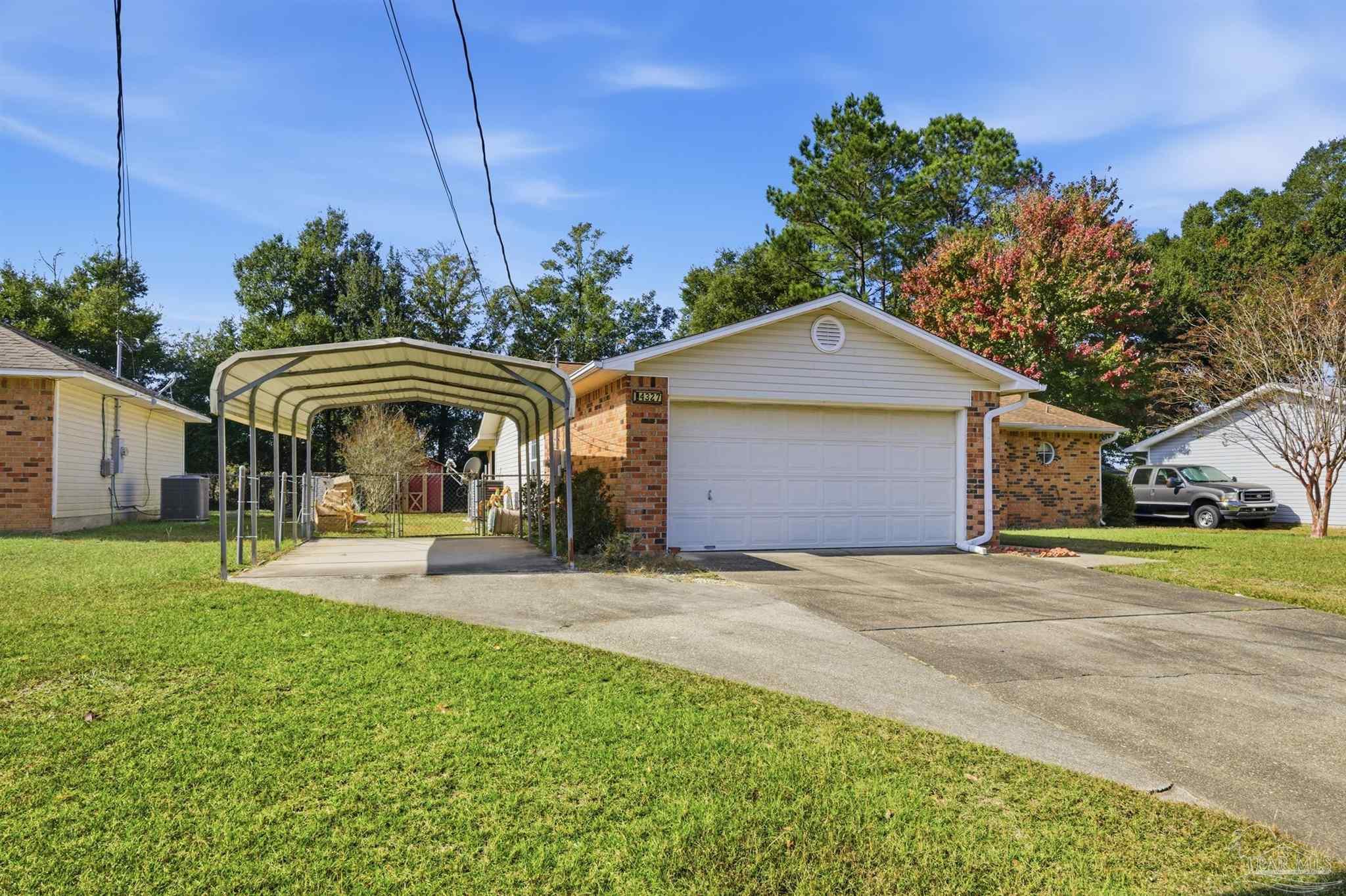 4327 Chantilly Way Milton, FL 32583 - Photo 31 of 32 a front view of a house with garden