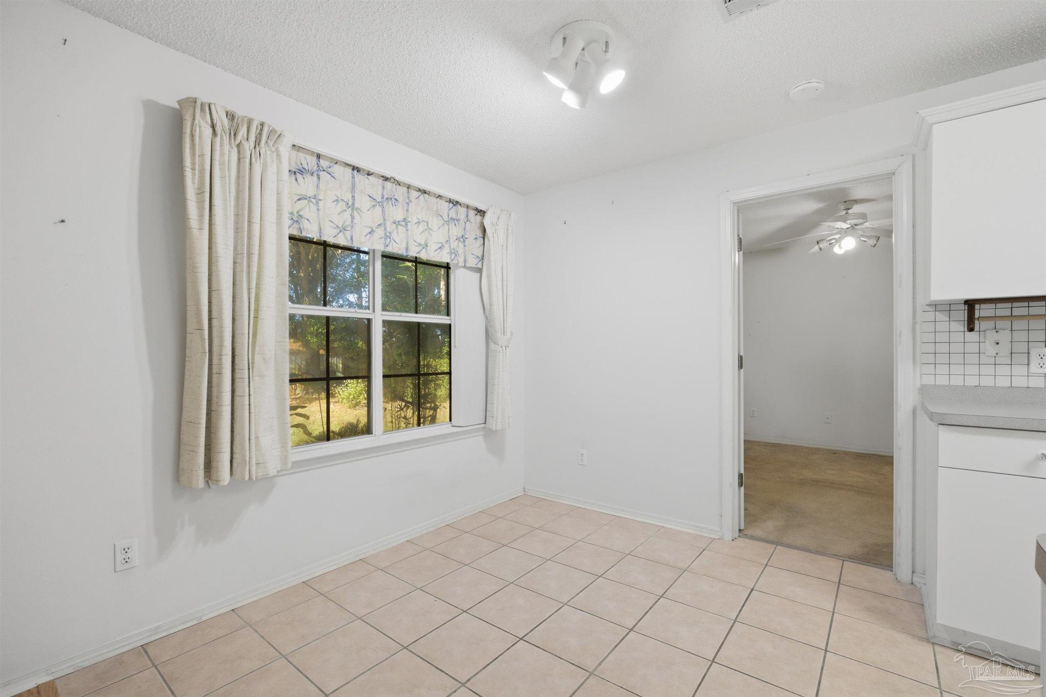 4327 Chantilly Way Milton, FL 32583 - Photo 8 of 32 a view of an empty room with window and cabinet