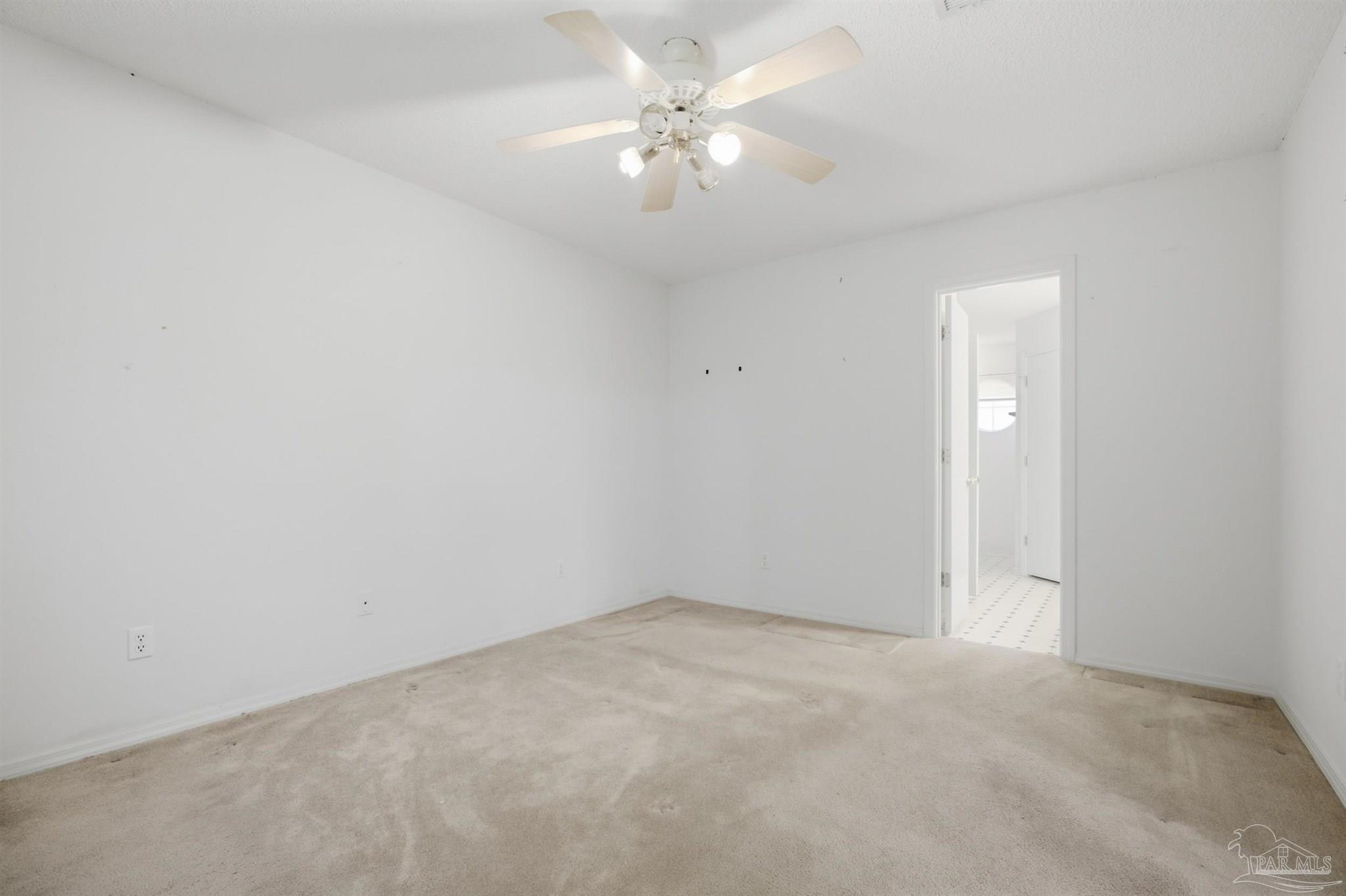4327 Chantilly Way Milton, FL 32583 - Photo 9 of 32 an empty room with a chandelier fan and windows