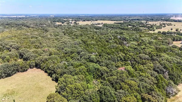 an aerial view of a houses with a yard