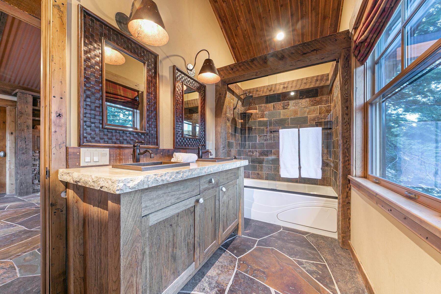 1768 Grouse Ridge Road Truckee, CA 96161 - Photo 17 of 28 a bathroom with a granite countertop sink and a large mirror