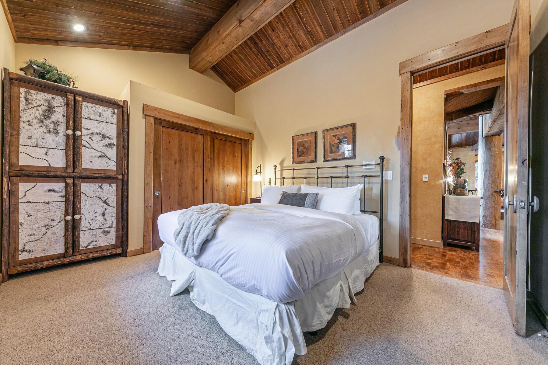 1768 Grouse Ridge Road Truckee, CA 96161 - Photo 18 of 28 a spacious bedroom with a bed next to a window