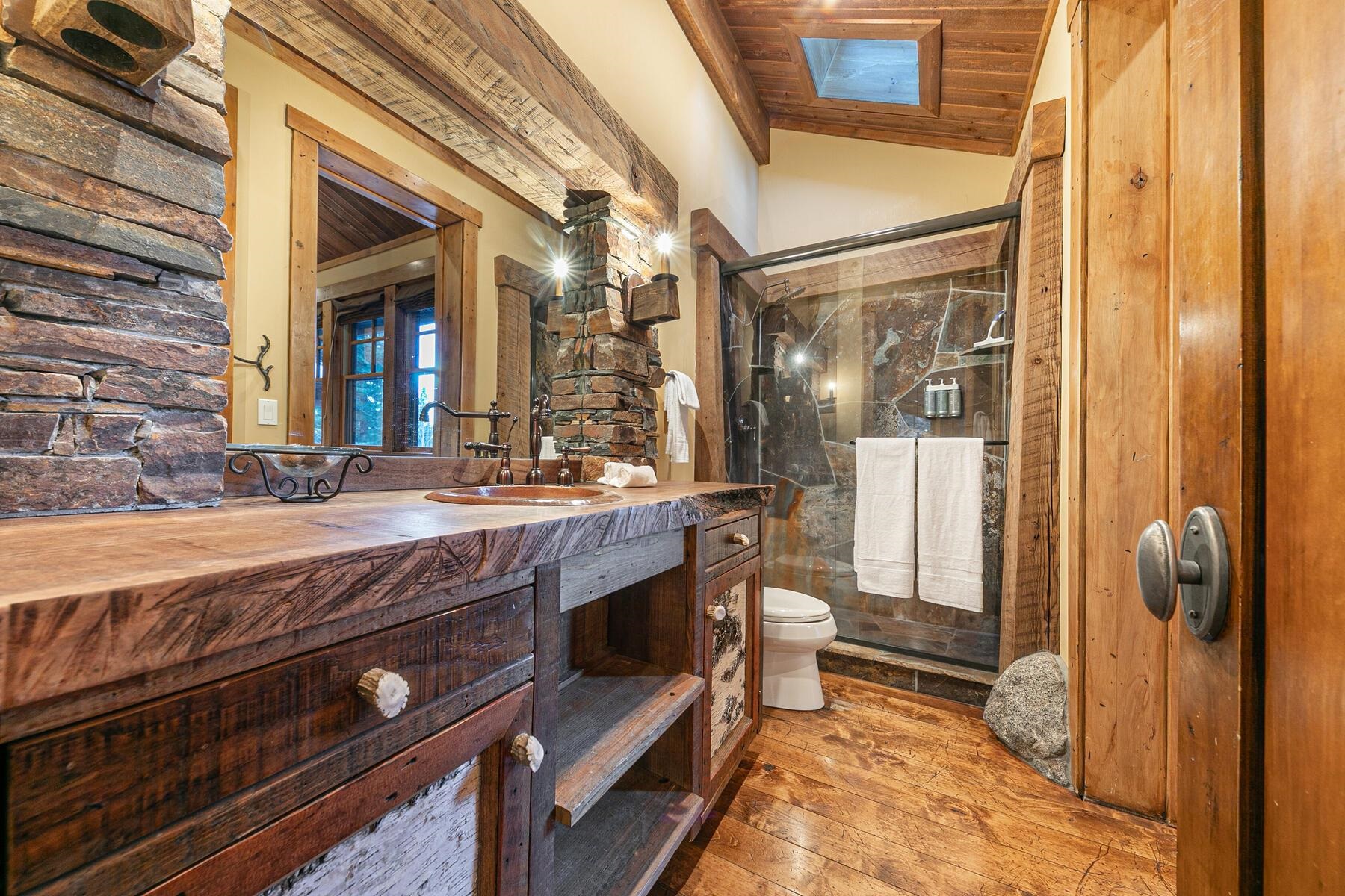 1768 Grouse Ridge Road Truckee, CA 96161 - Photo 19 of 28 a bathroom with a granite countertop sink a toilet and shower