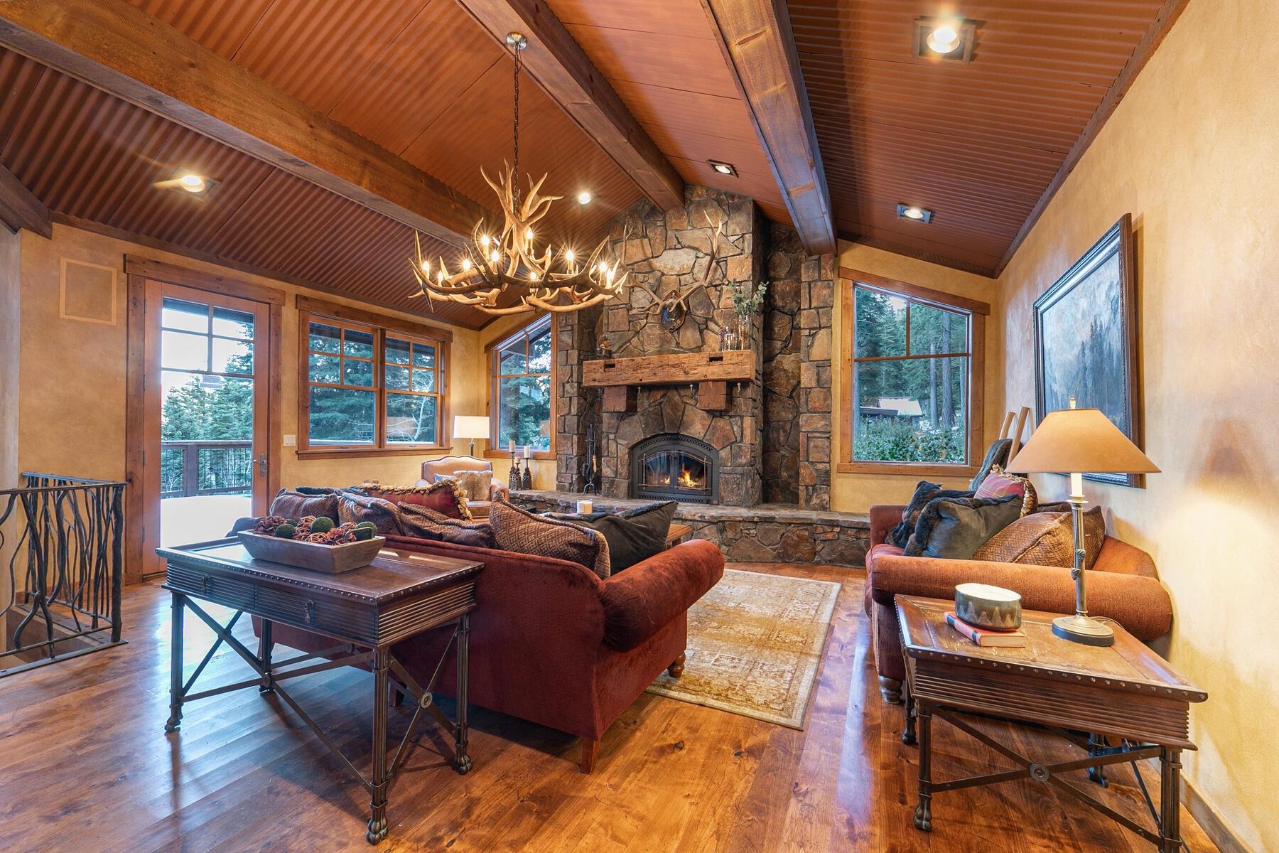 1768 Grouse Ridge Road Truckee, CA 96161 - Photo 8 of 28 a living room with furniture a chandelier and a fireplace
