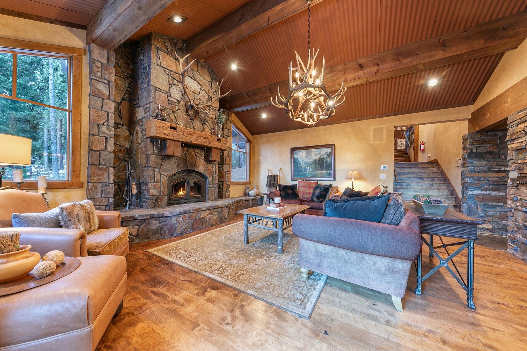 1768 Grouse Ridge Road Truckee, CA 96161 - Photo 10 of 28 a living room with furniture a fireplace and a chandelier