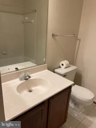 a bathroom with a sink toilet and a mirror