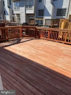 a view of a balcony with two chairs and wooden floor