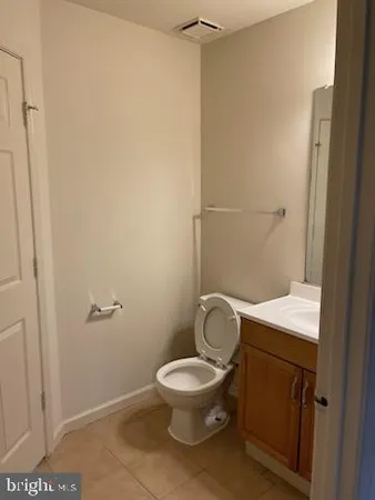 a white toilet sitting next to a shower
