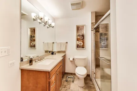a bathroom with a sink a toilet and a mirror
