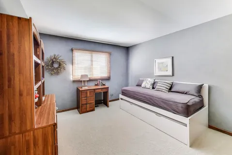 a spacious bedroom with a bed and a window