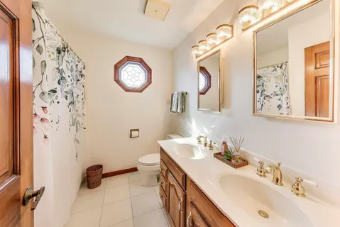 a living room with furniture a flat screen tv and a large window
