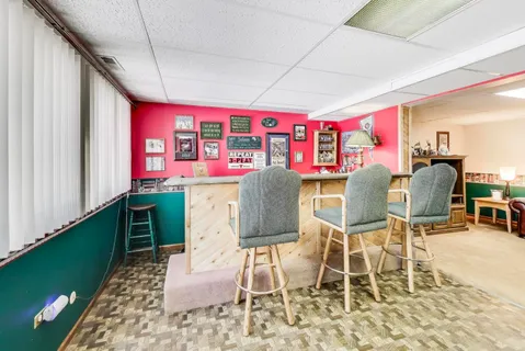 a view of a balcony with wooden floor and outdoor seating