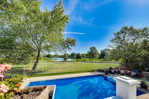 a view of house with yard and sitting area